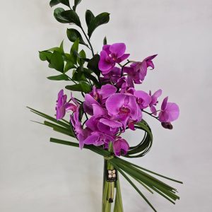 orquídeas Pink vaso de vidro e folhagem